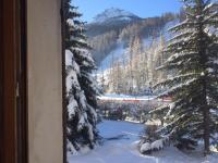 a view of a snow covered mountain from a window at Serre Chevalier -Cosy Apartment &quot;Le Coolidge&quot; for 7 down the slopes with stunning view in Saint-Chaffrey