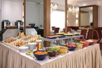 a buffet table with many bowls of food on it at Belere Urban Hotel Rabat in Rabat