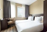 a hotel room with a large bed and a chair at Hotel Espresso in Amsterdam