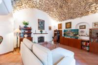 a living room with a couch and a fireplace at Casa Claudius - Positano in Positano