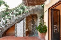 a stone building with a gate and a staircase at Casa Claudius - Positano in Positano