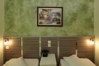 Postel nebo postele na pokoji v ubytování Socrates Hotel