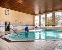a large swimming pool in a large room with windows at Quality Inn Airport in Colorado Springs