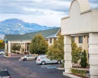 a building with cars parked in a parking lot at Quality Inn Airport in Colorado Springs