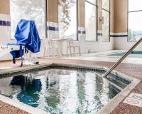 a pool in the middle of a building with water in it at Quality Inn Airport in Colorado Springs