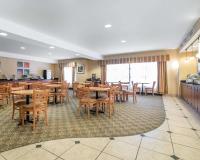 a dining room with wooden tables and chairs at Spark by Hilton Vestal Binghamton University Area in Vestal