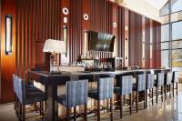 a bar in a room with wooden walls and chairs at Beijing Hotel Minsk in Minsk