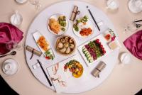 a white table with plates of food on it at Beijing Hotel Minsk in Minsk