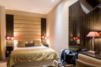 a bedroom with a bed and a large window at Hotel Boronali in Paris