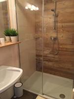 a shower with a glass door next to a sink at Appartement Pichler in Radstadt