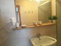 a bathroom with a sink and a mirror and a phone at Appartement Pichler in Radstadt