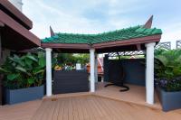 a gazebo with a green roof on a deck at Krabi Heritage Hotel in Ao Nang Beach