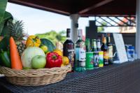 a basket of fruit and vegetables and bottles of wine at Krabi Heritage Hotel in Ao Nang Beach