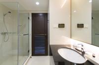 a bathroom with a sink and a glass shower at Krabi Heritage Hotel in Ao Nang Beach