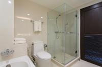 a bathroom with a toilet and a glass shower at Krabi Heritage Hotel in Ao Nang Beach