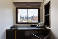 a desk in a room with a large window at Krabi Heritage Hotel in Ao Nang Beach