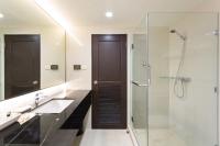 a bathroom with a shower and a sink and a mirror at Krabi Heritage Hotel in Ao Nang Beach