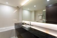 a bathroom with a sink and a large mirror at Krabi Heritage Hotel in Ao Nang Beach