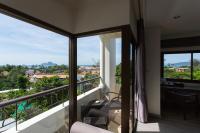 a room with a balcony with a view at Krabi Heritage Hotel in Ao Nang Beach