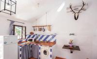 a kitchen with a sink and a washing machine at Finca El Huertezuelo in El Bosque