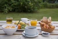 a table with a breakfast of coffee and bread and drinks at The Originals City, Hôtel Amys, Tarbes Sud (Inter-Hotel) in Odos