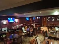 een eetkamer met tafels en stoelen en televisies bij Corriegarth Hotel in Inverness