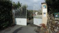 a pair of white gates in a driveway at Le Mas de Cascabel in Causse et Diege