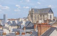 a view of a cathedral and roofs of buildings at Hotel Des Lices in Rennes