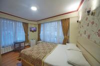 A bed or beds in a room at Hotel Akcinar