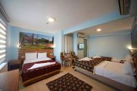 A bed or beds in a room at Hotel Akcinar