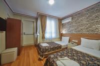 A bed or beds in a room at Hotel Akcinar