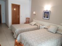 Postel nebo postele na pokoji v ubytování Hostal Centro