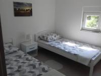 Postel nebo postele na pokoji v ubytování Apartman Bunarić