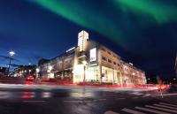 a building on a city street at night with green lights at Original Sokos Hotel Vaakuna Rovaniemi in Rovaniemi