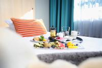 a table with a tray of food on a bed at Original Sokos Hotel Vaakuna Rovaniemi in Rovaniemi