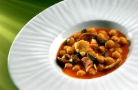 a white plate with a bowl of food on a plate at Hotel Echaurren Relais & Châteaux in Ezcaray