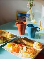 a table with two plates of food and a cup of coffee at Yurong B&amp;B in Magong