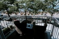 a balcony with chairs and a view of a parking lot at StrandHotel Seeblick, Ostseebad Heikendorf in Heikendorf