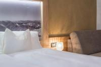 A bed or beds in a room at Das Hochegg - Apartments