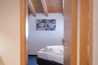 A bed or beds in a room at Das Hochegg - Apartments