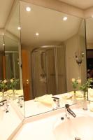 a bathroom with two sinks and a large mirror at Panoramahotel &amp; Restaurant am Marienturm in Rudolstadt