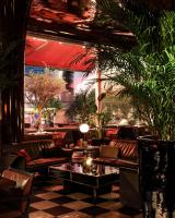 a restaurant with leather couches and tables and plants at Hotel Les Bains Paris in Paris