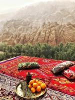 a table with a plate of oranges on top at Monkey Fingers House by Fatima mellal in Tinerhir