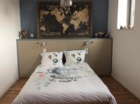 a bedroom with a bed with a map on the wall at Les terrasses de l’orchestre in Amiens