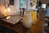 a table with several glasses and a pitcher of milk at Brulee&#39;s Done in Dongshan