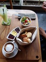 a table with a tray of food and a cup of coffee at Wasabi in Canggu