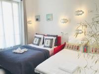 a bedroom with two beds and a window at Nice Appart in Nice