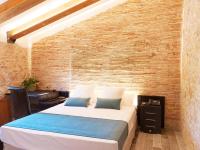Posteľ alebo postele v izbe v ubytovaní Hotel Molí de l'Escala