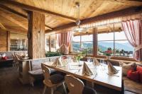a dining room with a long table and chairs at Apartments Pitschlmann in Fiè