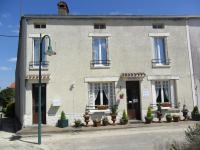 a building with potted plants in front of it at Chambres d&#39;Hôtes Bienvenue in LʼAbsie